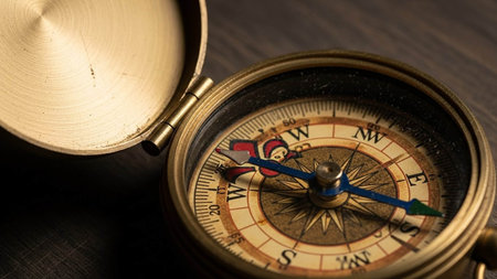 Compass on a wooden table. Vintage style. Selective focus.の写真素材