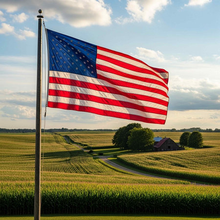 American flag waving in the wind over a farm field in the countrysideの写真素材