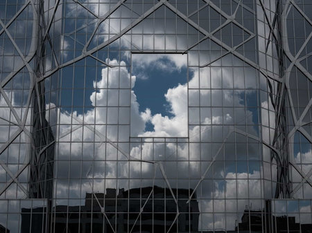 Clouds reflected in the glass facade of a modern office building.の写真素材