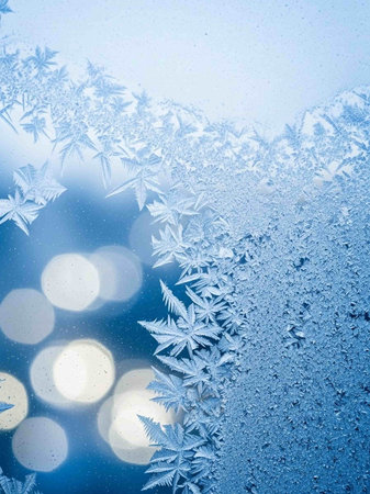 Frosty natural pattern on winter window glass with bokeh background