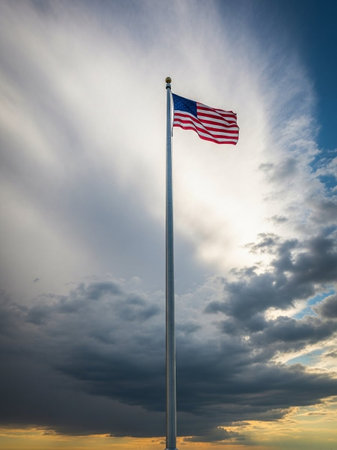 American flag waving in the wind against a stormy sky with cloudsの写真素材
