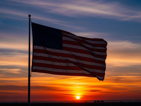 American flag waving in the wind on a background of a beautiful sunsetの写真素材