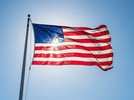 American flag waving in the wind on blue sky background. United States of America.の写真素材