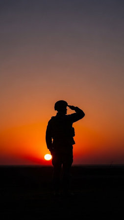Silhouette of a soldier at sunset in the desert of Moroccoの写真素材