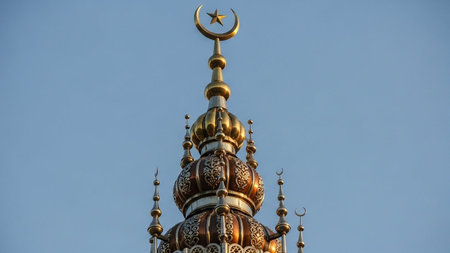 Mosque with golden dome and crescent moon on blue sky backgroundの写真素材