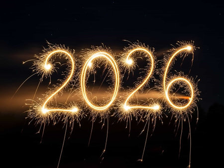 Happy new year written with Sparkle firework on black sky backgroundの写真素材