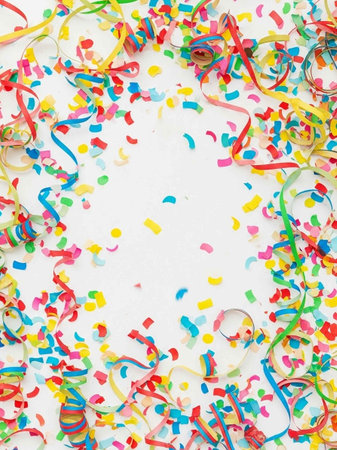 Colorful confetti and streamers on a white background with copy spaceの写真素材