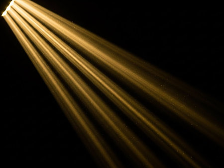 stage lighting effect on a black background with rays of light and smokeの写真素材