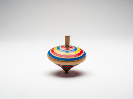 Colorful wooden spinning top on a white background with copy space.の写真素材