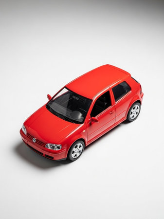Red car model on white background. Minimal style. Front view.