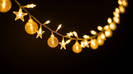 Christmas lights on a black background with bokeh defocused lightsの写真素材