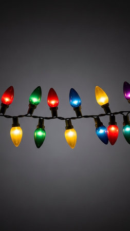 Colorful Christmas lights on a gray background. Selective focus.
