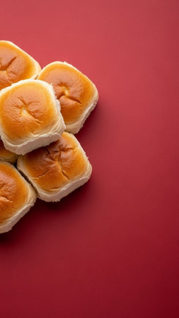 top view of fresh baked buns on red background with copy spaceの写真素材
