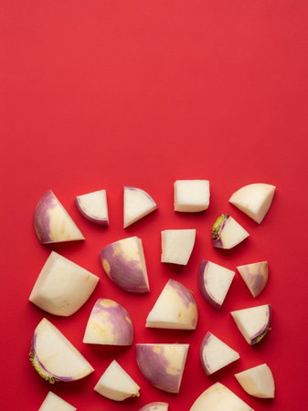 top view of fresh purple vegetable slices on red background with copy spaceの写真素材