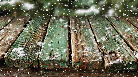 Wooden table covered with snow and snowflakes. Christmas backgroundの写真素材