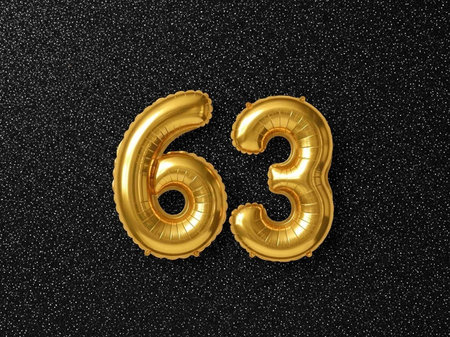 Number 66 gold foil balloon on black glitter background. Birthday or anniversary celebration...