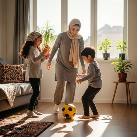 muslim mother and children playing soccer at home. family holiday conceptの写真素材
