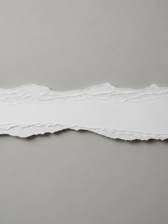 Torn white paper with space for your message on grey background.の写真素材