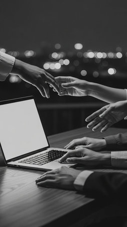 Business people working with laptop at night. Black and white image.の写真素材