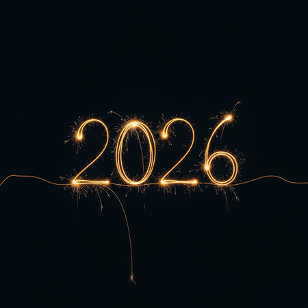 Happy new year written with sparklers on a black background.の写真素材