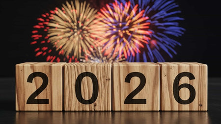 Wooden cubes with the numbers 2026 and fireworks on a black backgroundの写真素材