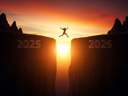 Happy new year concept. Happy young man jumping from cliff to the sunsetの写真素材