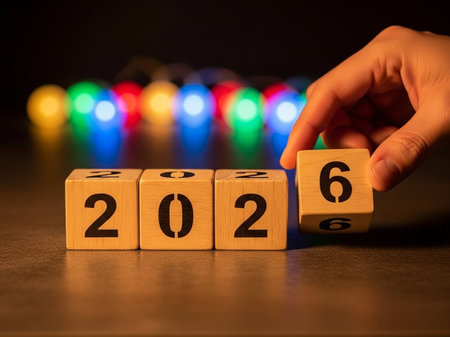 New year concept on wooden cubes with colorful bokeh backgroundの写真素材