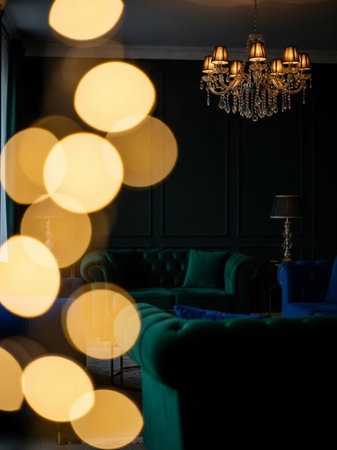 Luxury living room interior with green sofa, lamps and bokehの写真素材