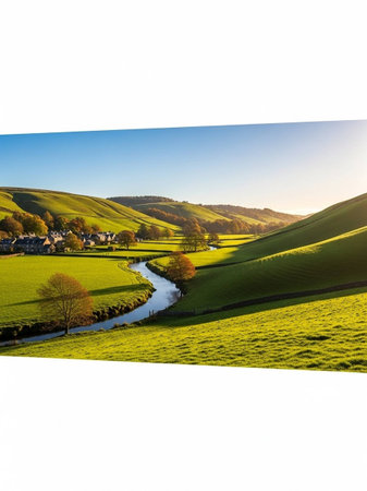 Idyllic rural landscape with a small river flowing through the hills