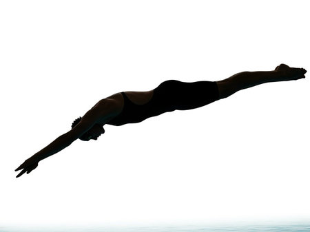 Silhouette of a girl in swimsuit jumping on white backgroundの写真素材