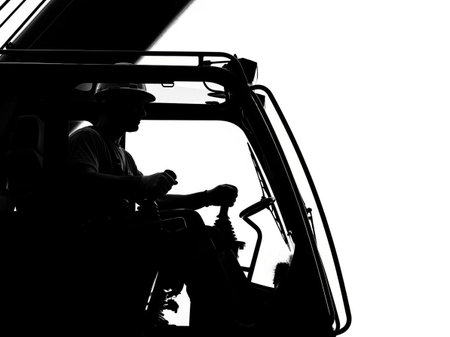 Silhouette of a car mechanic working on a construction site.の写真素材