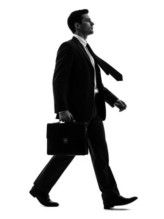 one caucasian business man walking full length silhouette isolated on white backgroundの写真素材
