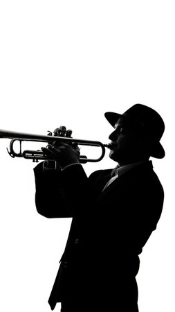 Silhouette of a jazz musician playing the trumpet on white backgroundの写真素材