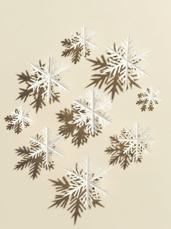 Snowflakes on beige background. Minimal winter concept.の写真素材