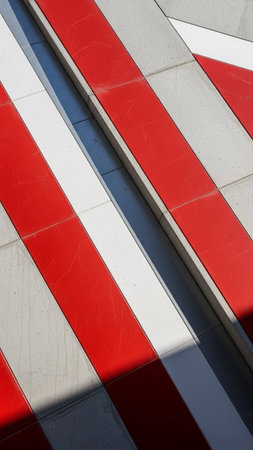 Detail of the facade of a modern building with red and white stripesの写真素材