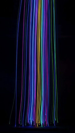 Multicolored light trails on a black background. Long exposure.の写真素材