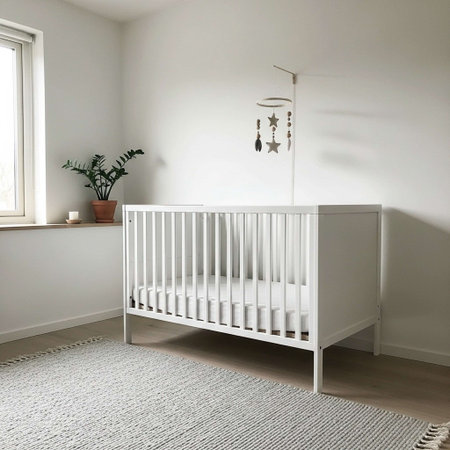 A serene nursery with a white crib and a plant on the windowsill