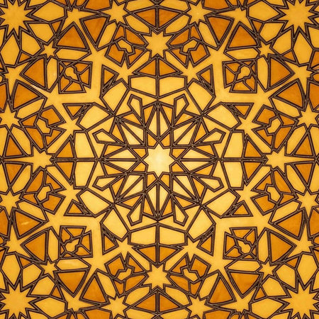 A vibrant and intricate geometric pattern in shades of orange and yellowの写真素材