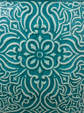 A close-up view of a vibrant teal and white patterned tile designの写真素材