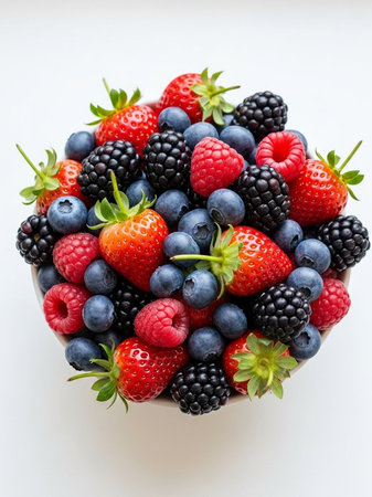 A vibrant mix of fresh berries in a bowl from aboveの写真素材