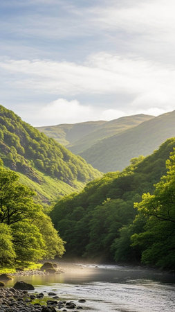 A serene landscape of a river flowing through a lush green valley surrounded by mountains under a...