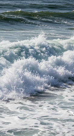 A close-up view of ocean waves crashing with white foam and blue water
