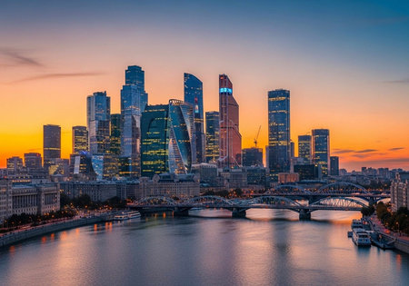 A vibrant sunset over Moscow's modern skyline, featuring illuminated skyscrapers, a river, and...
