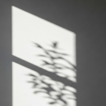 A blurry black and white photo of a tree branch seen through a window