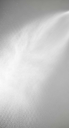 A close-up view of a textured metallic surface with a beam of light shining on it
