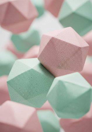 A close-up view of pastel-colored geometric shapes in pink and green huesの写真素材
