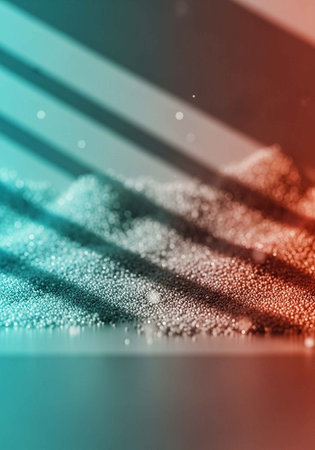 A close-up view of sand with vibrant blue and orange shadows cast across itの写真素材