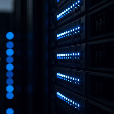 A close-up view of a server room with rows of computer servers and blue lightsの写真素材