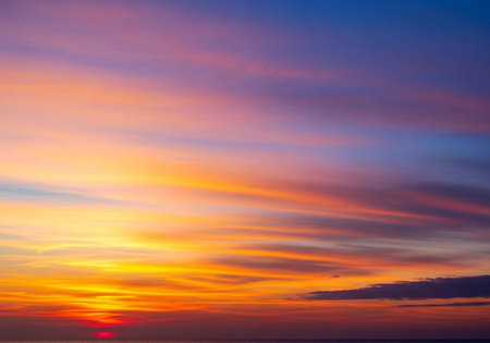 A vibrant sunset with colorful clouds in the evening skyの写真素材