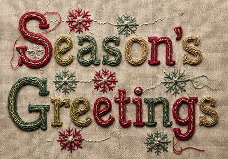 Embroidered text "Season's Greetings" with colorful threads and snowflakes on a beige background.の写真素材